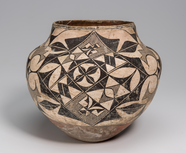 A jar with geometric shapes and natural forms in black, white, and red.