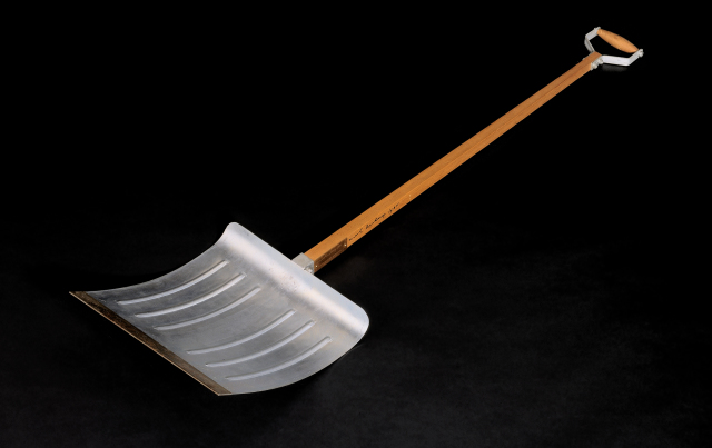 A snow shovel with a wood handle and aluminum scoop.